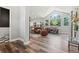 Open-concept living room with vaulted ceilings, fireplace, and hardwood floors that flow to the kitchen at 6532 S Tempe St, Aurora, CO 80016