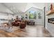 Bright living room with vaulted ceilings, large windows, and hardwood floors open to kitchen at 6532 S Tempe St, Aurora, CO 80016