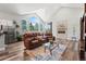 Bright living room featuring vaulted ceilings, fireplace, and hardwood floors flowing into the kitchen at 6532 S Tempe St, Aurora, CO 80016