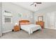 Neutral main bedroom with carpet, dresser and three windows at 6532 S Tempe St, Aurora, CO 80016