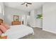 Neutral main bedroom with carpet, ensuite bathroom and tv at 6532 S Tempe St, Aurora, CO 80016
