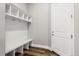 Mudroom features a bench with storage cubbies and hooks, adjacent to an entry door at 6532 S Tempe St, Aurora, CO 80016