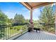 Relaxing covered patio with wrought iron railing and flower boxes, with views of the lush, green landscape at 6532 S Tempe St, Aurora, CO 80016