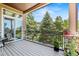 Outdoor patio with stone columns, iron railing, and scenic views of the surrounding landscaping at 6532 S Tempe St, Aurora, CO 80016