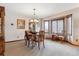 Traditional dining room with a wooden table, chairs, and elegant chandelier, perfect for Gathering meals at 5209 S Zeno Way, Aurora, CO 80015