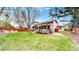 Expansive backyard offers a lush lawn, an inviting patio, and mature trees, perfect for entertaining and outdoor activities at 540 Columbine Ave, Broomfield, CO 80020