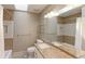A well-lit bathroom featuring dual sinks, a spacious vanity, and a shower with a tiled backsplash at 540 Columbine Ave, Broomfield, CO 80020