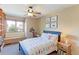 A bedroom featuring a blue bedframe, window seat, and charming decor at 540 Columbine Ave, Broomfield, CO 80020