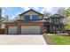Attractive home exterior featuring a three-car garage, brick accents, and a well-kept lawn at 540 Columbine Ave, Broomfield, CO 80020