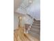 Elegant foyer features a staircase with white railings, light hardwood floors, and natural light at 540 Columbine Ave, Broomfield, CO 80020