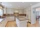 Gourmet kitchen with a large center island, white cabinets, and professional-grade appliances at 540 Columbine Ave, Broomfield, CO 80020