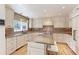 Spacious kitchen featuring custom cabinets, a center island, and stainless steel appliances at 540 Columbine Ave, Broomfield, CO 80020