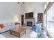 Bright living room featuring a stone fireplace, hardwood floors, and built-in bookshelves at 540 Columbine Ave, Broomfield, CO 80020