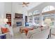 Living room with a stone fireplace, built-in bookshelves, and large windows offering backyard views at 540 Columbine Ave, Broomfield, CO 80020