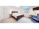 Spacious bedroom with a large window, dark wood bed frame, and TV at 540 Columbine Ave, Broomfield, CO 80020