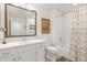 Bright bathroom featuring a vanity with sink, toilet, and shower-tub combo with patterned curtain at 25049 E Alder Dr, Aurora, CO 80016