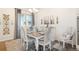 The dining room features a table for six, elegant decor, and a sliding glass door with gray curtains at 25049 E Alder Dr, Aurora, CO 80016