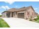Charming single-Gathering home with stone accents, a two-car garage, and a manicured front yard at 25049 E Alder Dr, Aurora, CO 80016