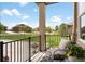 Inviting covered front porch area with comfortable seating, decorative flowers, and an iron railing at 25049 E Alder Dr, Aurora, CO 80016
