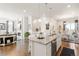 Open concept kitchen with granite countertops and seamless transition to living and dining areas at 25049 E Alder Dr, Aurora, CO 80016