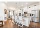 Bright kitchen boasts granite counters, stainless appliances, and a cozy breakfast bar with three chairs at 25049 E Alder Dr, Aurora, CO 80016
