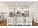 Bright kitchen boasts white cabinetry, granite countertops, and stainless steel appliances at 25049 E Alder Dr, Aurora, CO 80016