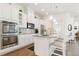 Modern kitchen features white cabinets, granite countertops, and stainless steel appliances at 25049 E Alder Dr, Aurora, CO 80016