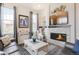 Cozy living room with a stone fireplace, television, and stylish decor at 25049 E Alder Dr, Aurora, CO 80016