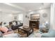 Inviting living room with cozy furniture, decorative accents, and a large screen TV for entertainment at 25049 E Alder Dr, Aurora, CO 80016