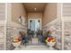 Charming covered patio with stone accents, comfortable seating, and inviting outdoor ambiance at 25049 E Alder Dr, Aurora, CO 80016
