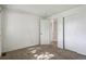 Bright bedroom featuring a sliding door closet and neutral carpet at 2826 S Lansing Way, Aurora, CO 80014