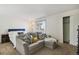 Comfortable bedroom features a gray couch and closet at 2826 S Lansing Way, Aurora, CO 80014