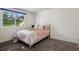 Cozy bedroom featuring neutral carpet and a large window for natural light at 2826 S Lansing Way, Aurora, CO 80014