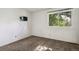 This bedroom features a large window and a mounted television at 2826 S Lansing Way, Aurora, CO 80014