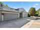 Exterior of the building with multiple garages and a well-kept facade on a sunny day at 2826 S Lansing Way, Aurora, CO 80014