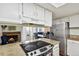 Bright, updated kitchen with stainless steel appliances and views into dining area with fireplace at 2826 S Lansing Way, Aurora, CO 80014