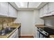Bright kitchen with updated appliances, cabinetry and countertops with plenty of storage space at 2826 S Lansing Way, Aurora, CO 80014