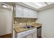 The kitchen has been updated with stainless steel dishwasher and sink and wood look flooring at 2826 S Lansing Way, Aurora, CO 80014