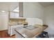 The kitchen features updated appliances, stone countertops, and barstool seating at 2826 S Lansing Way, Aurora, CO 80014