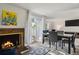 Living room with fireplace and table, bathed in natural light from a sliding glass door at 2826 S Lansing Way, Aurora, CO 80014