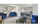 Open-concept living area with modern furnishings, a staircase, and ample seating space at 2826 S Lansing Way, Aurora, CO 80014