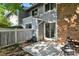 A small outdoor seating area with a sliding glass door leading to the home's interior and a small, manicured garden at 2826 S Lansing Way, Aurora, CO 80014