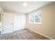 Bright bedroom featuring neutral walls, plush carpeting, large window, and spacious closet at 2880 S Olathe Ct, Aurora, CO 80013