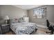 Comfortable bedroom with hardwood floors, a plush bed, and a bright window at 10115 W 25Th Ave # 1, Lakewood, CO 80215