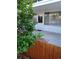 Welcoming entrance with white door, adjacent window, and a lush green shrub at 10115 W 25Th Ave # 1, Lakewood, CO 80215