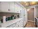 Bright kitchen featuring white cabinets, modern appliances, and tile flooring at 10115 W 25Th Ave # 1, Lakewood, CO 80215