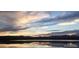 Scenic lake view with serene water reflecting colorful sky and silhouette of mountains at 10115 W 25Th Ave # 1, Lakewood, CO 80215