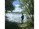 Person is pictured with fishing pole by lakeside enjoying a tranquil outdoor setting at 10115 W 25Th Ave # 1, Lakewood, CO 80215