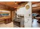 Rustic kitchen with stainless steel appliances and wood cabinetry at 20958 Taos Rd, Indian Hills, CO 80454