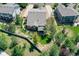 An aerial view shows a backyard with landscaping and a screened in porch in a residential neighborhood at 3419 Traver Dr, Broomfield, CO 80023